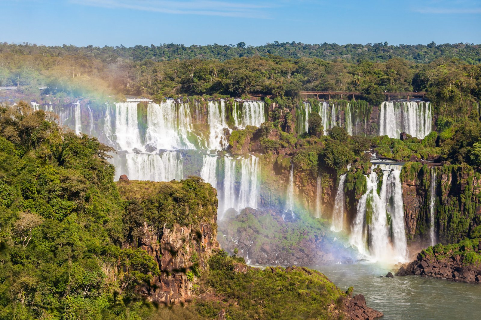 Rainbow and Iguazu Falls. Iguazu Falls are waterfalls of the Iguazu River on the border of the Argentina and the Brazil.